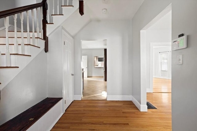 interior space featuring vaulted ceiling and hardwood / wood-style flooring