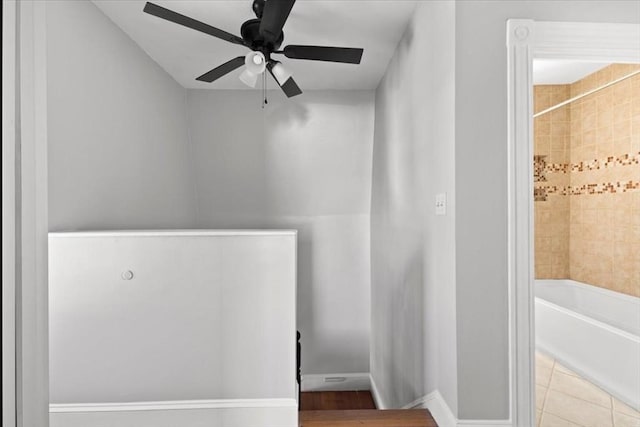 bathroom featuring ceiling fan and bathtub / shower combination