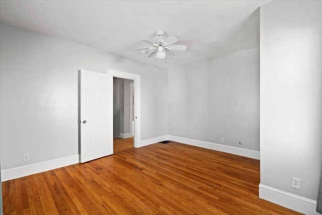 spare room featuring hardwood / wood-style flooring and ceiling fan