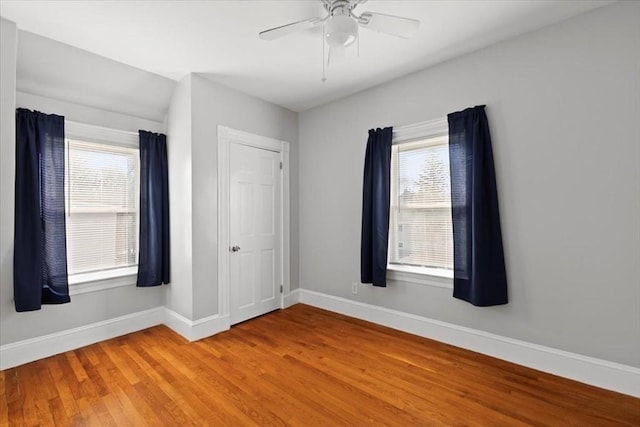 empty room with ceiling fan and hardwood / wood-style floors