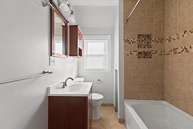 full bathroom featuring toilet, vanity, tiled shower / bath, and tile patterned flooring