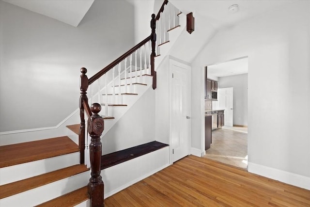 staircase with hardwood / wood-style floors