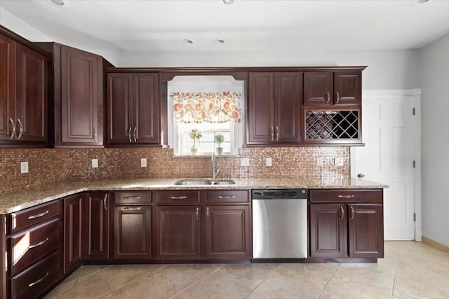 kitchen with light stone counters, sink, decorative backsplash, and dishwasher