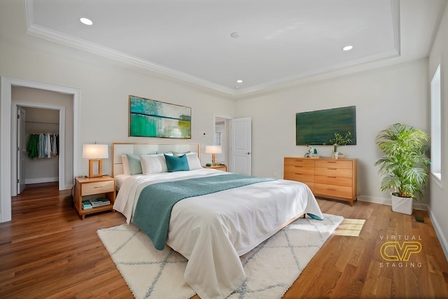 bedroom with ornamental molding and hardwood / wood-style flooring