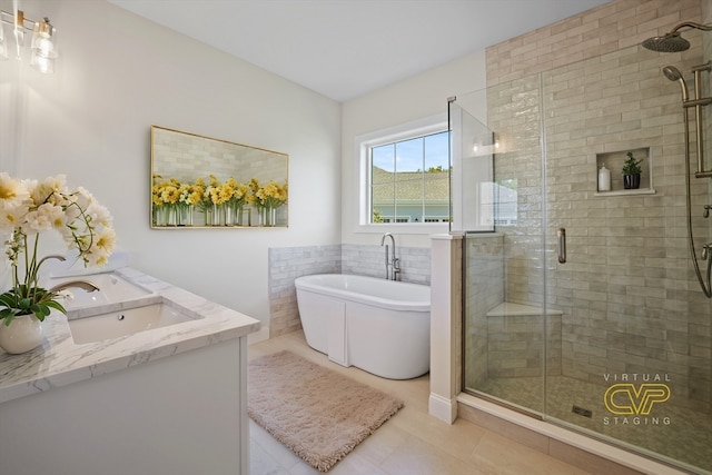 bathroom featuring tile walls, vanity, separate shower and tub, and tile patterned floors