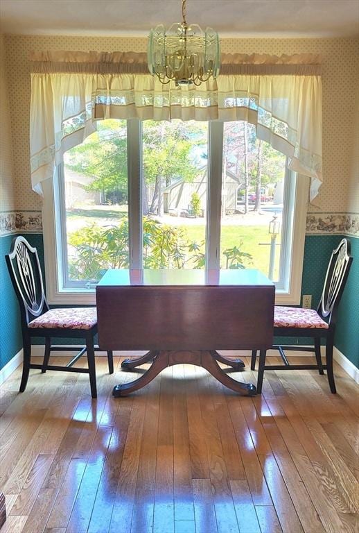 15 Iris Way Unit 27, Haverhill, MA 01830 - dining area featuring wallpapered walls, a chandelier, hardwood / wood-style floors, and baseboards
