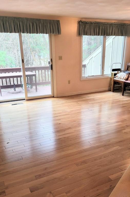 15 Iris Way Unit 27, Haverhill, MA 01830 - unfurnished living room with wood-type flooring, plenty of natural light, and baseboards