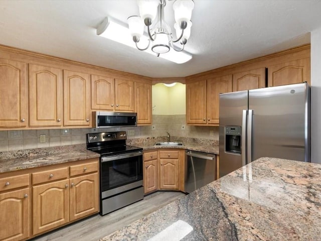 44 Casablanca Ct Unit 44, Haverhill, MA 01832 - kitchen with appliances with stainless steel finishes, light wood-style floors, a chandelier, and stone countertops
