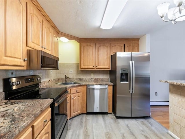 44 Casablanca Ct Unit 44, Haverhill, MA 01832 - kitchen featuring appliances with stainless steel finishes, light wood finished floors, a sink, a baseboard radiator, and stone counters