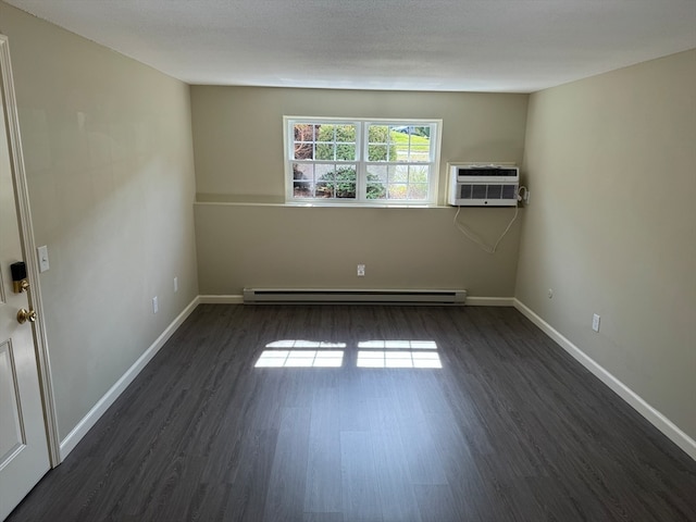 unfurnished room featuring a baseboard radiator, dark hardwood / wood-style flooring, and a wall unit AC