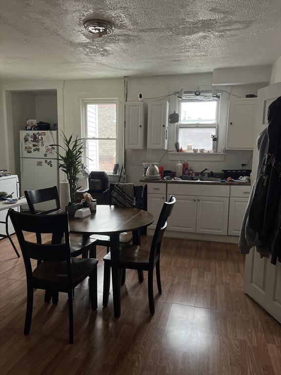 dining room featuring plenty of natural light, dark hardwood / wood-style flooring, and sink