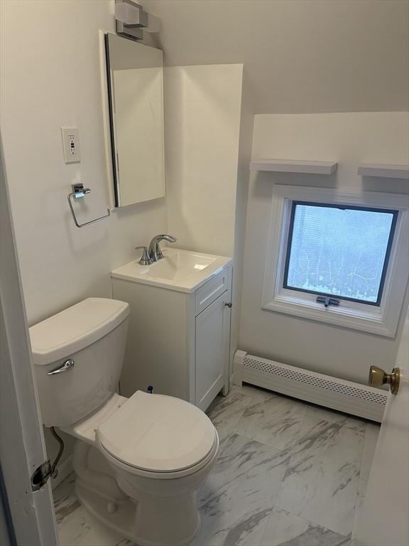 bathroom featuring a baseboard radiator, vanity, and toilet