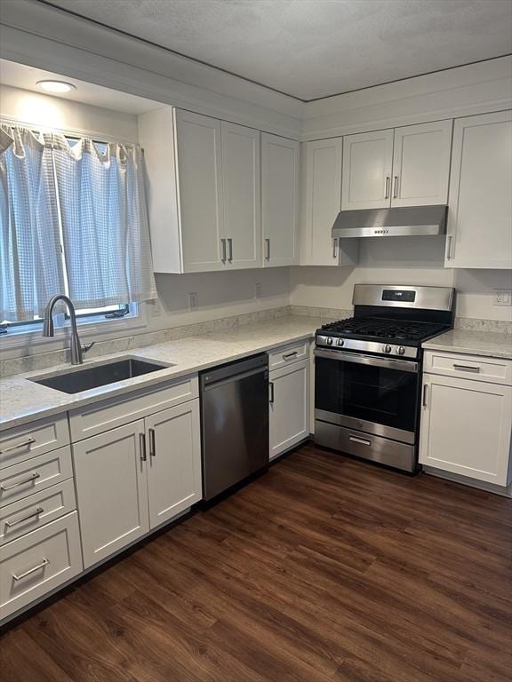 kitchen with white cabinetry, appliances with stainless steel finishes, dark wood-type flooring, and sink