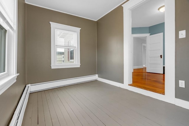 unfurnished room featuring a baseboard radiator and hardwood / wood-style flooring