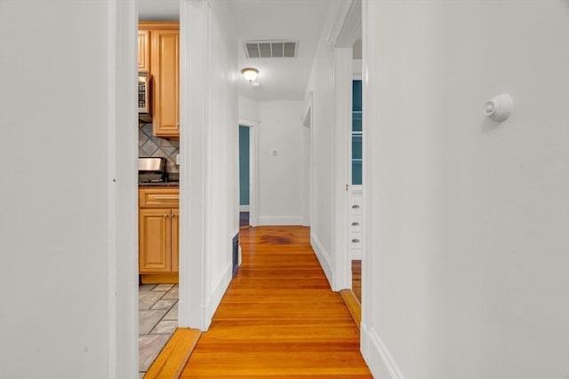 corridor featuring light hardwood / wood-style flooring