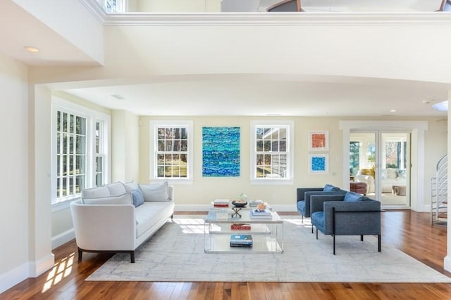 living room with recessed lighting, wood-type flooring, and baseboards