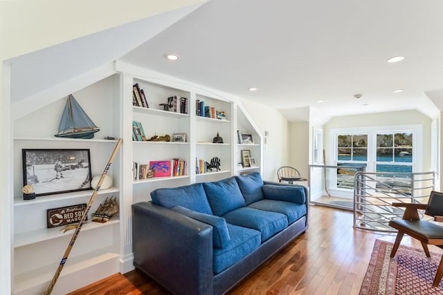 living area with built in shelves, vaulted ceiling, hardwood / wood-style floors, and recessed lighting