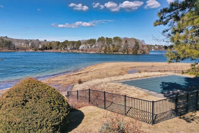 property view of water featuring fence