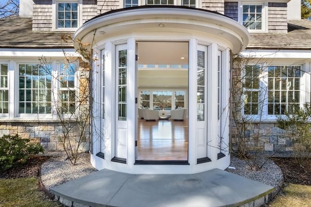 entrance to property featuring stone siding