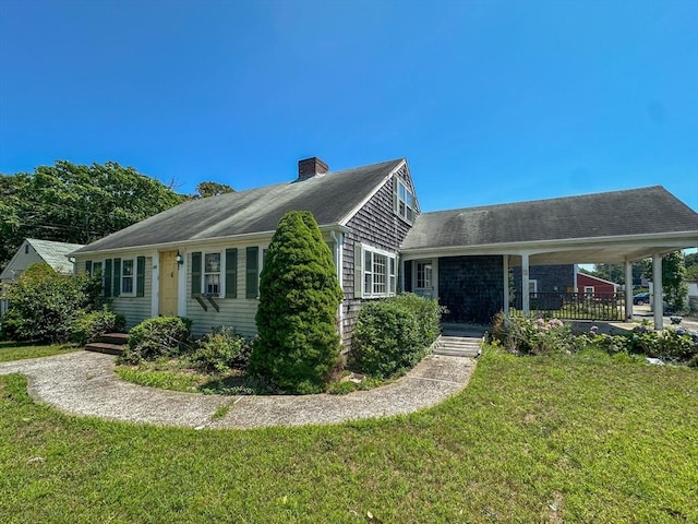 ranch-style house with a carport and a front lawn