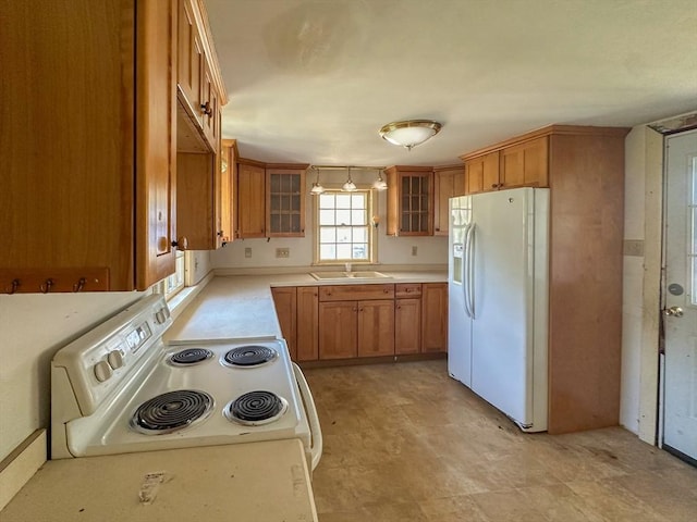 kitchen featuring white appliances and sink