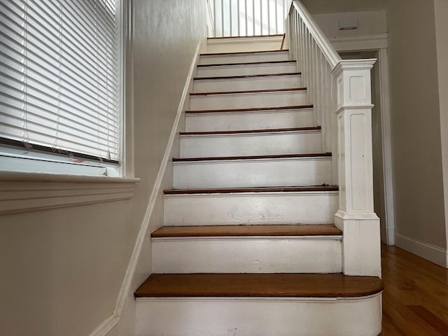 stairway with hardwood / wood-style flooring