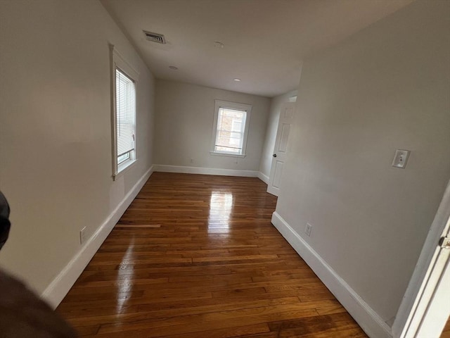 unfurnished room with dark hardwood / wood-style flooring