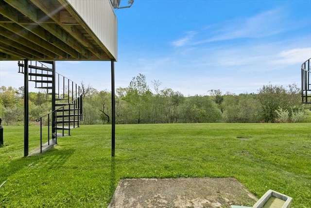 view of green lawn with stairway