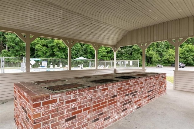 view of patio featuring fence and view of wooded area