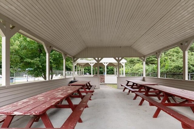 surrounding community with outdoor dining space, a patio, and fence