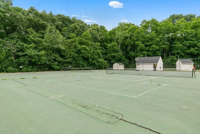 view of tennis court featuring fence
