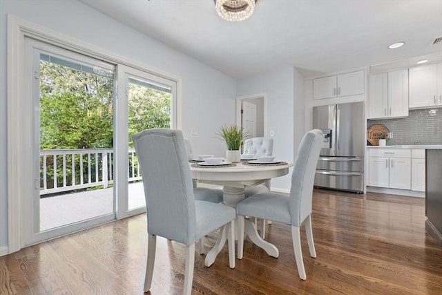 dining area featuring dark wood-style flooring