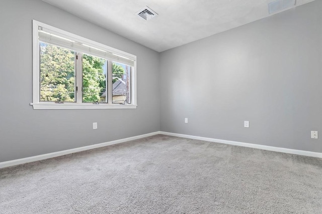 carpeted empty room with baseboards
