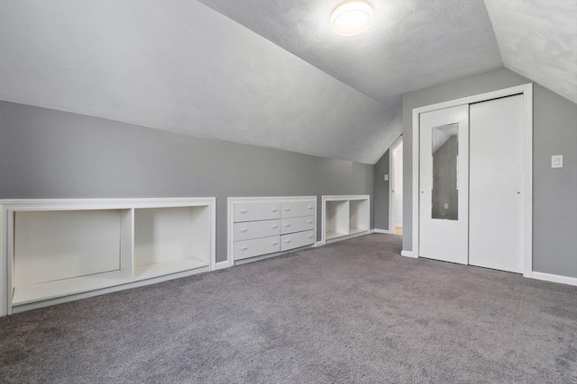 additional living space with vaulted ceiling, carpet, and baseboards
