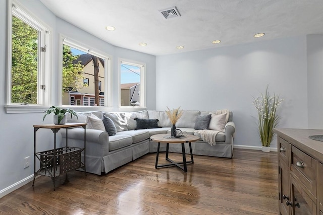 living room with plenty of natural light, dark wood-style flooring, baseboards, and recessed lighting