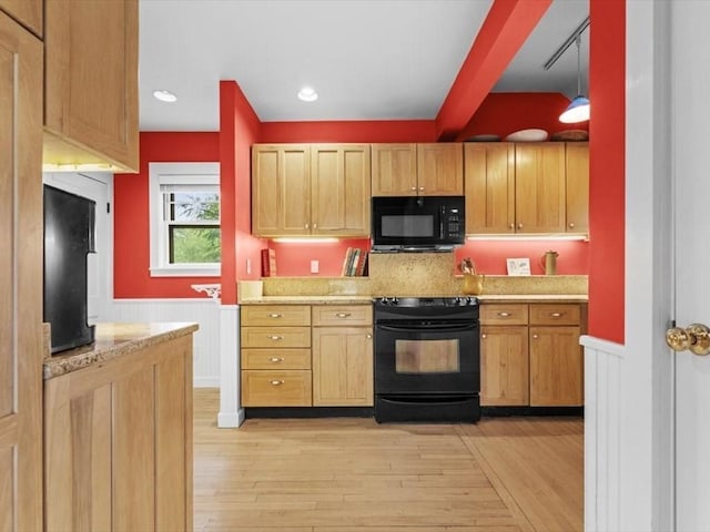 49 Fern Rd, Medford, MA 02155 - kitchen with black appliances, a wainscoted wall, light wood-style flooring, and light brown cabinetry