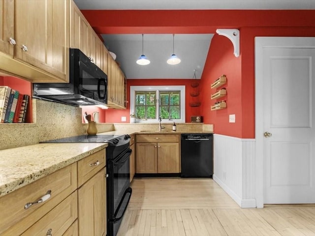 49 Fern Rd, Medford, MA 02155 - kitchen featuring black appliances, light wood-style floors, a wainscoted wall, vaulted ceiling, and light stone countertops