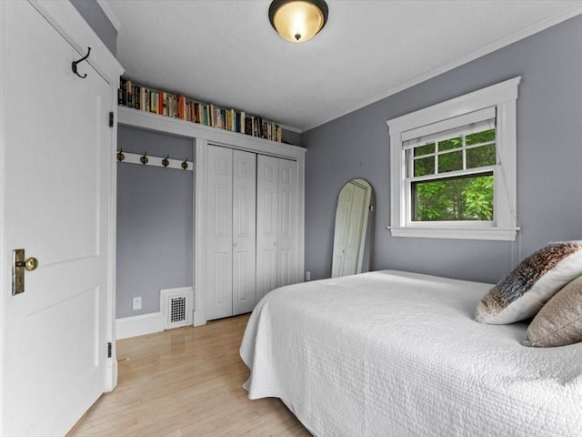 49 Fern Rd, Medford, MA 02155 - bedroom with light wood-style floors, ornamental molding, a closet, and baseboards