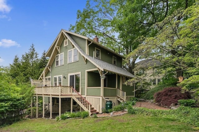 49 Fern Rd, Medford, MA 02155 - back of property featuring stairway, a chimney, a deck, roof with shingles, and a yard
