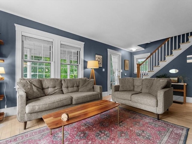49 Fern Rd, Medford, MA 02155 - living room featuring stairs, wood finished floors, plenty of natural light, baseboards, and ornamental molding
