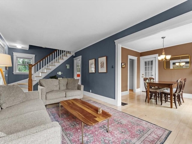 49 Fern Rd, Medford, MA 02155 - living area featuring a chandelier, stairs, baseboards, wood finished floors, and crown molding