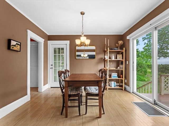 49 Fern Rd, Medford, MA 02155 - dining space featuring a chandelier, baseboards, light wood-style floors, and ornamental molding