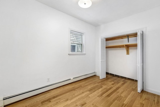 281 Chelsea St Unit 2A, Boston, MA 02128 - unfurnished bedroom featuring baseboard heating, light wood-style floors, and a closet