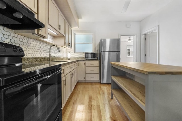 281 Chelsea St Unit 2A, Boston, MA 02128 - kitchen with appliances with stainless steel finishes, wooden counters, under cabinet range hood, open shelves, and decorative backsplash