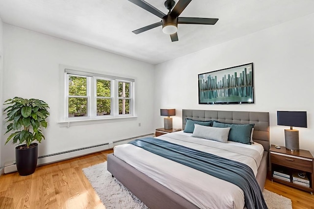 281 Chelsea St Unit 2A, Boston, MA 02128 - bedroom with light wood-style floors, a baseboard heating unit, and a ceiling fan