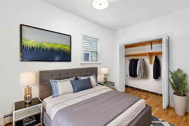 281 Chelsea St Unit 2A, Boston, MA 02128 - bedroom featuring a baseboard radiator, a closet, and wood finished floors