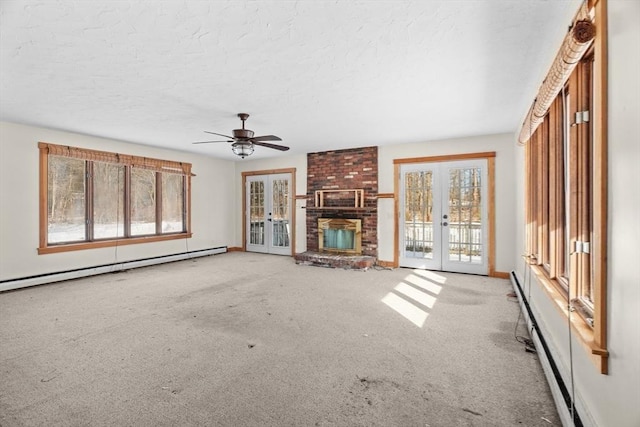 1210 Highland St, Holliston, MA 01746 - unfurnished living room with french doors, carpet flooring, baseboard heating, a textured ceiling, and a brick fireplace