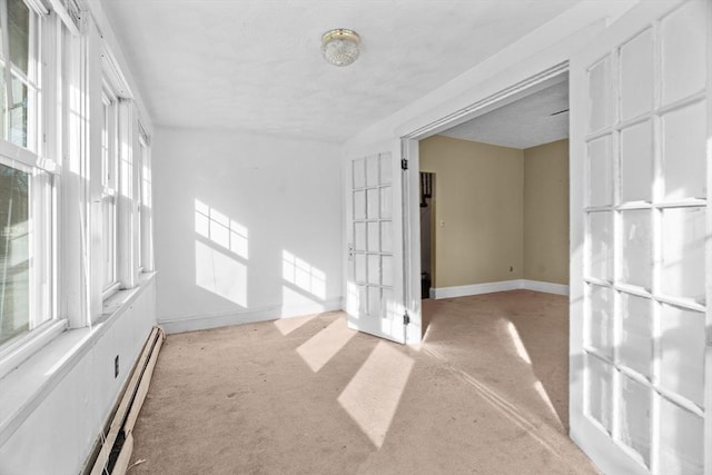 1210 Highland St, Holliston, MA 01746 - spare room featuring light colored carpet, a baseboard heating unit, baseboard heating, and a textured ceiling