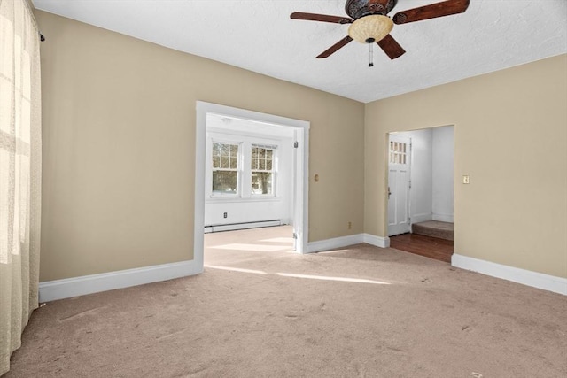 1210 Highland St, Holliston, MA 01746 - carpeted spare room featuring baseboard heating, a ceiling fan, and a textured ceiling