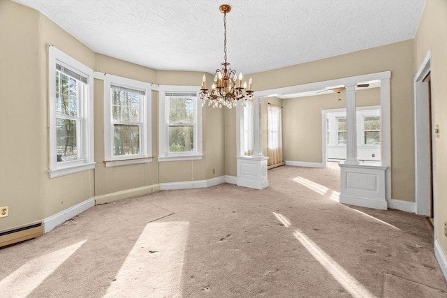 1210 Highland St, Holliston, MA 01746 - unfurnished dining area with healthy amount of natural light, a chandelier, a textured ceiling, carpet floors, and decorative columns